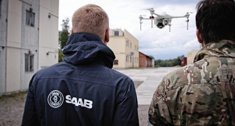 Saab personnel demonstrating the UAV trainer