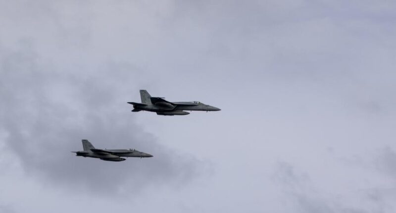 US Navy F/A-18E Super Hornets perform a fly-by