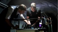 Defence Science and Technology Group scientist Ben Sparkes, left, works with Australian-built quantum clocks at the University of Adelaide.