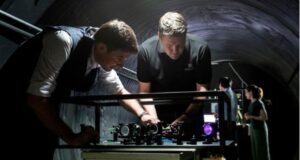 Defence Science and Technology Group scientist Ben Sparkes, left, works with Australian-built quantum clocks at the University of Adelaide.