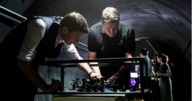 Defence Science and Technology Group scientist Ben Sparkes, left, works with Australian-built quantum clocks at the University of Adelaide.