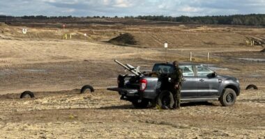 The Merops counter-drone system placed on a black truck bed with a soldier operating it.