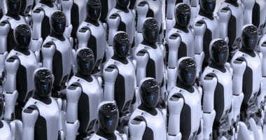 Rows of humanoid combat robots stand in formation, featuring white armored bodies and black visors with blue digital displays, resembling a mass-produced autonomous fleet