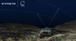 Military vehicle operating at night in rugged terrain, equipped with a satellite terminal linking to overhead satellites for secure communications.