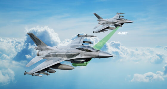Two F-16 fighter jets flying in formation above the clouds, connected via a highlighted MANET data link for networked targeting and situational awareness.