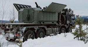 Rheinmetall Ragnarok 120mm truck-mounted mortar with open roof panels positioned in a winter landscape, showcasing its shoot-and-scoot mobile fires capability