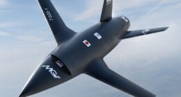 The MGI Engineering T-022 Vortex autonomous collaborative combat aircraft flying against a high-altitude blue sky, designed for UK manned-unmanned teaming operations.