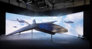 The stealthy BAE Systems Brontanax uncrewed autonomous fighter drone prototype on stage at the Farnborough Airshow, developed under the UK's Storm Fighter sovereign CCA program.