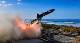 The MGI Defence TigerShark high-speed one-way effector launching from a coastal rail system with rocket booster ignition during test firings.